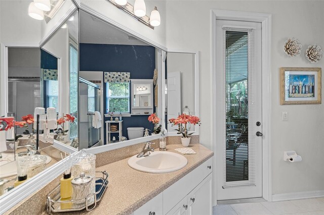bathroom featuring vanity, tile patterned floors, and a stall shower