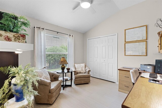 home office with vaulted ceiling and a ceiling fan