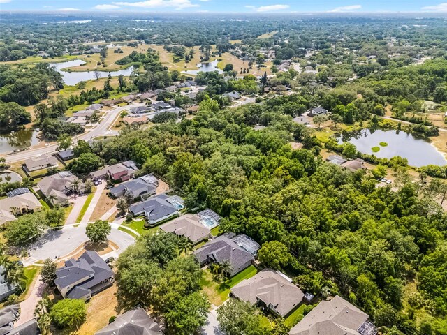drone / aerial view featuring a water view and a residential view
