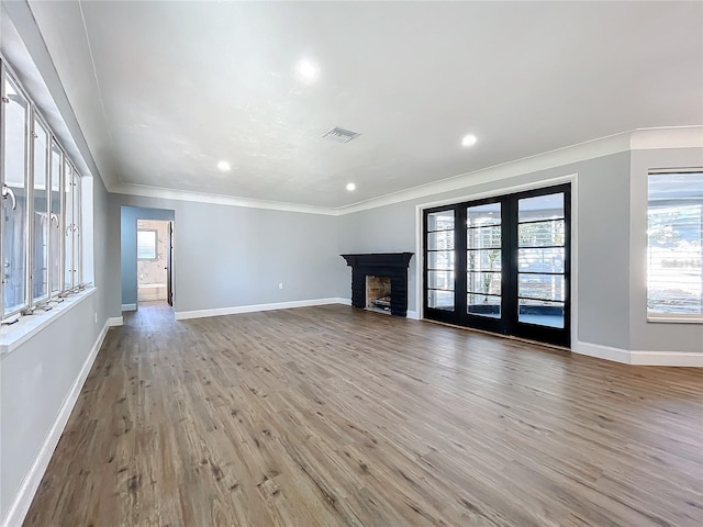 905 W 11th Ave, Mount Dora, FL 32757 - unfurnished living room featuring crown molding, baseboards, light wood finished floors, a fireplace, and recessed lighting