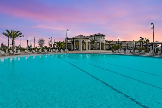 9025 Dogleg Dr, Davenport, FL 33896 - pool at dusk featuring a community pool