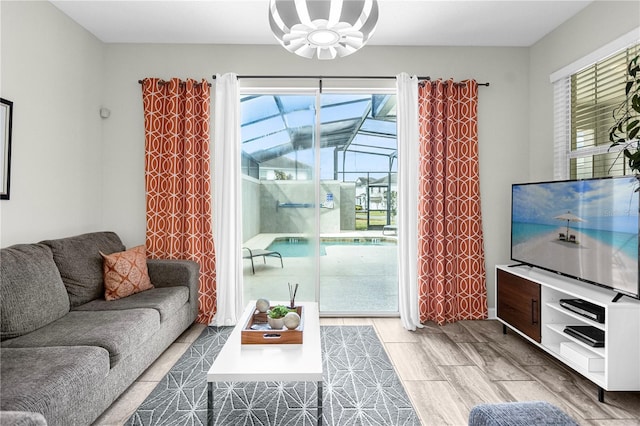 9025 Dogleg Dr, Davenport, FL 33896 - living room with wood finished floors and an inviting chandelier