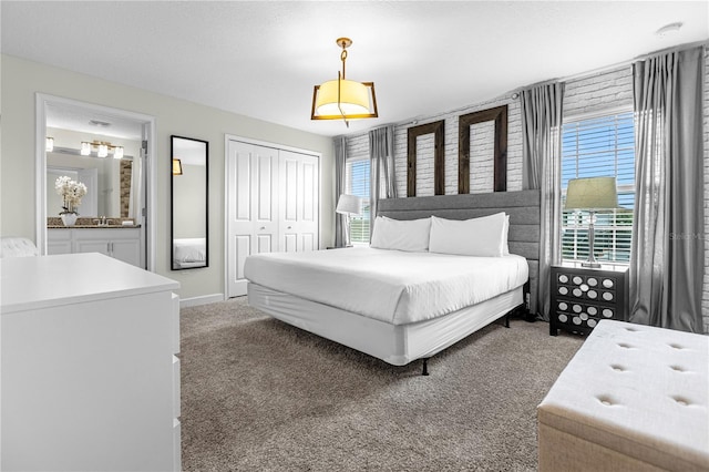 9025 Dogleg Dr, Davenport, FL 33896 - carpeted bedroom with a closet, baseboards, a sink, and connected bathroom