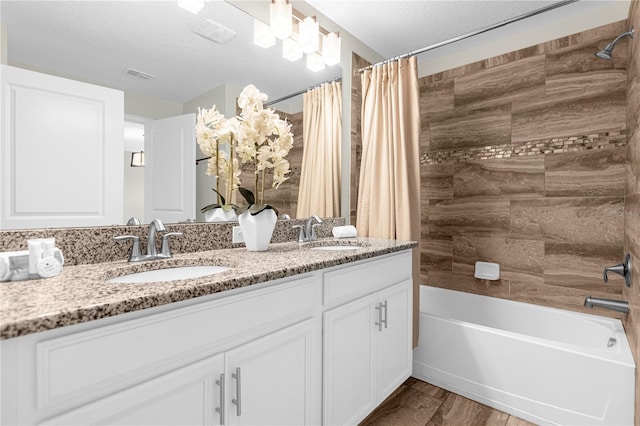 9025 Dogleg Dr, Davenport, FL 33896 - full bathroom with double vanity, visible vents, shower / bath combo with shower curtain, and a sink