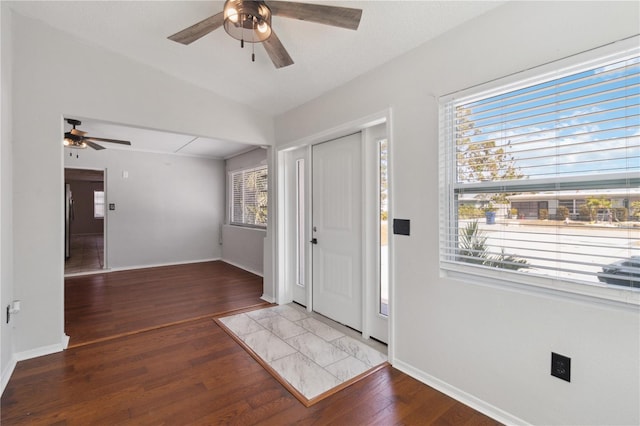 foyer entrance featuring a ceiling fan, wood finished floors, and baseboards
