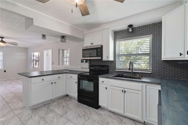 kitchen featuring stainless steel microwave, black / electric stove, dark countertops, ceiling fan, and a peninsula
