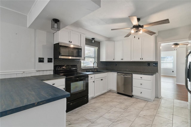 kitchen with dark countertops, ceiling fan, stainless steel appliances, and plenty of natural light