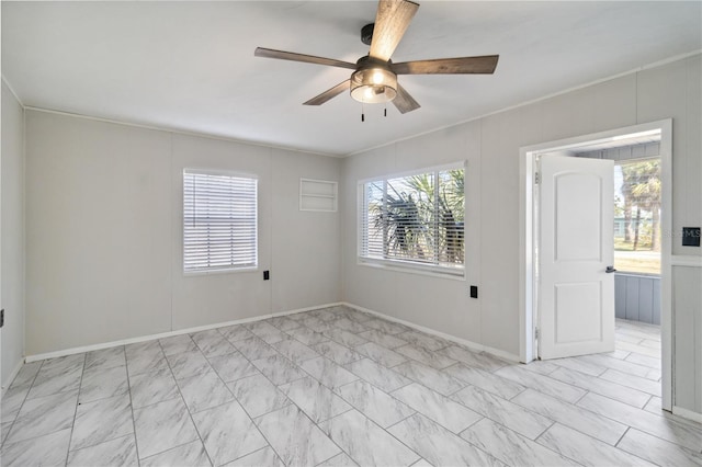 unfurnished room with ceiling fan and crown molding