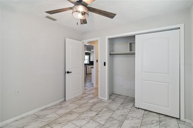 unfurnished bedroom featuring a closet, ceiling fan, marble finish floor, visible vents, and baseboards