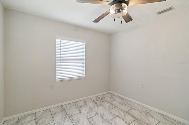 spare room with baseboards, visible vents, a ceiling fan, and marble finish floor