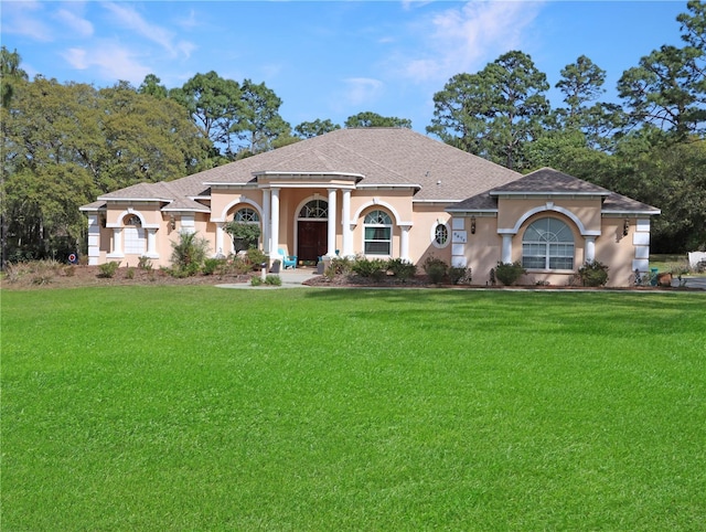 4675 Ficus Dr, Beverly Hills, FL 34465 - view of front of property featuring stucco siding, a front yard, and a shingled roof