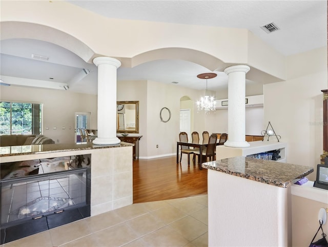 4675 Ficus Dr, Beverly Hills, FL 34465 - kitchen featuring light tile patterned floors, arched walkways, visible vents, and ornate columns