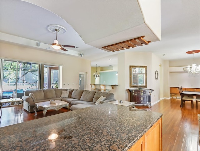 4675 Ficus Dr, Beverly Hills, FL 34465 - living room with baseboards, wood finished floors, and ceiling fan with notable chandelier