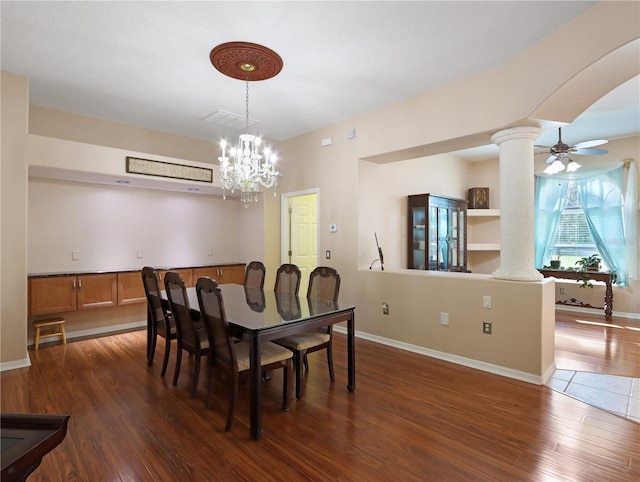 4675 Ficus Dr, Beverly Hills, FL 34465 - dining room featuring ornate columns, visible vents, baseboards, wood finished floors, and ceiling fan with notable chandelier