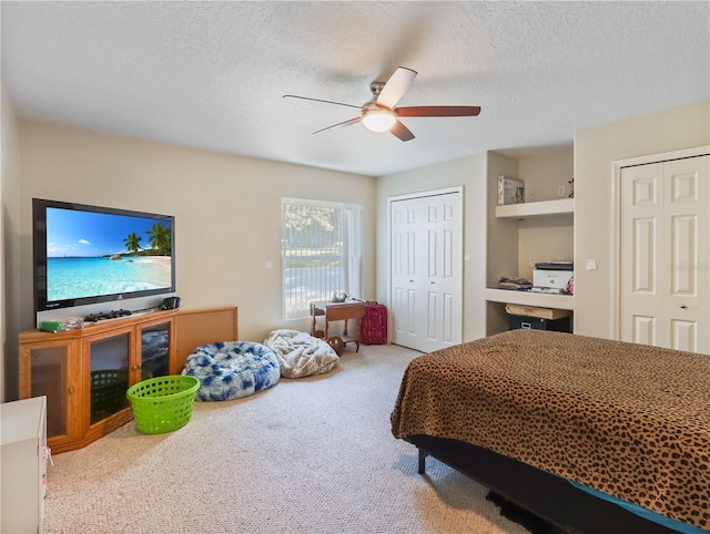 4675 Ficus Dr, Beverly Hills, FL 34465 - bedroom with a textured ceiling, two closets, ceiling fan, and carpet floors
