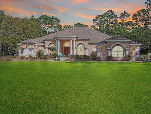 4675 Ficus Dr, Beverly Hills, FL 34465 - view of front of house with stucco siding, roof with shingles, and a front lawn