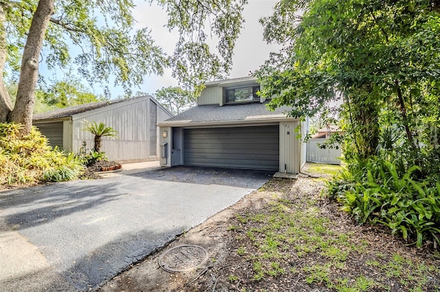 121 Primrose Dr, Longwood, FL 32779 - view of front of house featuring an attached garage and asphalt driveway
