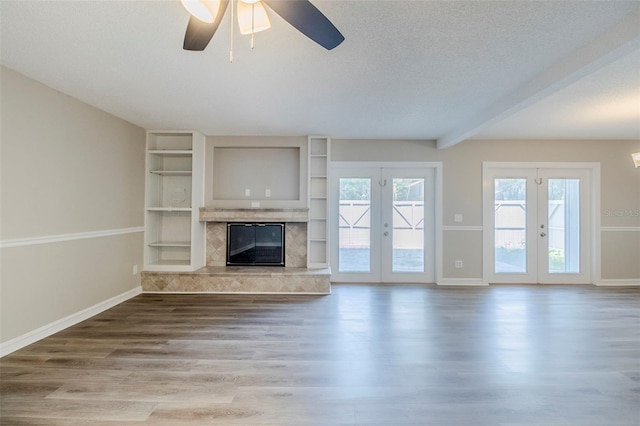 121 Primrose Dr, Longwood, FL 32779 - unfurnished living room with french doors, ceiling fan, wood finished floors, baseboards, and a fireplace