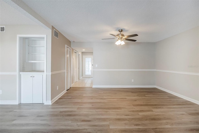 121 Primrose Dr, Longwood, FL 32779 - spare room featuring a ceiling fan, a textured ceiling, light wood-type flooring, and baseboards
