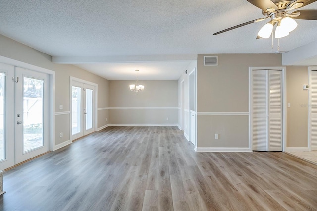 121 Primrose Dr, Longwood, FL 32779 - unfurnished living room with a textured ceiling, a chandelier, light wood-style floors, french doors, and baseboards