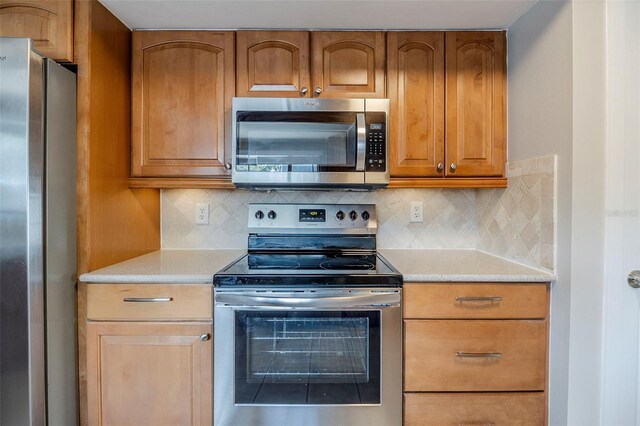 121 Primrose Dr, Longwood, FL 32779 - kitchen featuring appliances with stainless steel finishes, light countertops, and backsplash