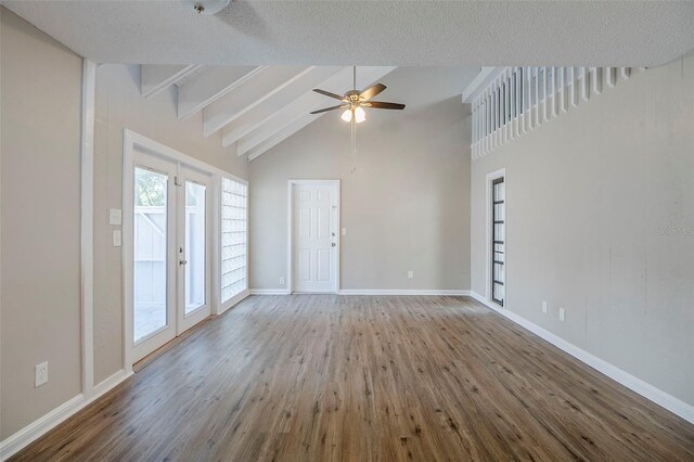 121 Primrose Dr, Longwood, FL 32779 - unfurnished living room with wood finished floors, beam ceiling, ceiling fan, baseboards, and high vaulted ceiling