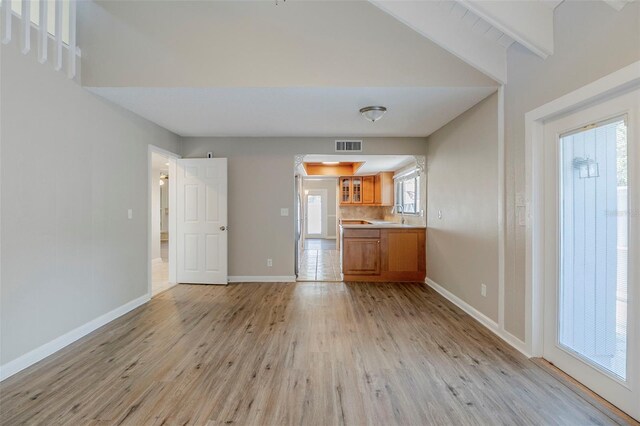 121 Primrose Dr, Longwood, FL 32779 - unfurnished living room with light wood-style floors, baseboards, and a sink