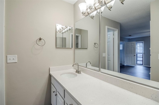 121 Primrose Dr, Longwood, FL 32779 - bathroom featuring vanity, a chandelier, and a textured ceiling