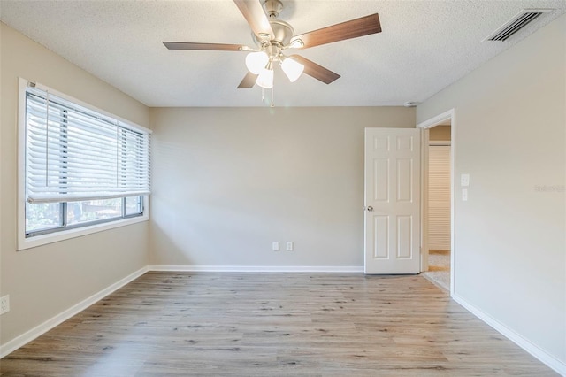 121 Primrose Dr, Longwood, FL 32779 - spare room featuring light wood-style floors, a textured ceiling, a ceiling fan, and baseboards