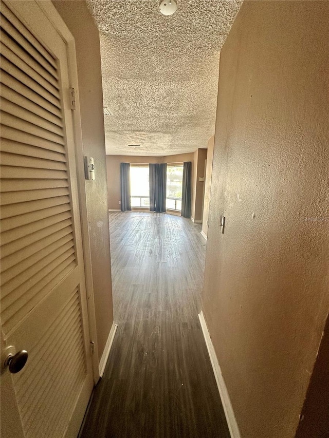 4350 Aqua Vista Dr Unit G, Orlando, FL 32839 - hall featuring a textured ceiling, a textured wall, wood finished floors, and baseboards