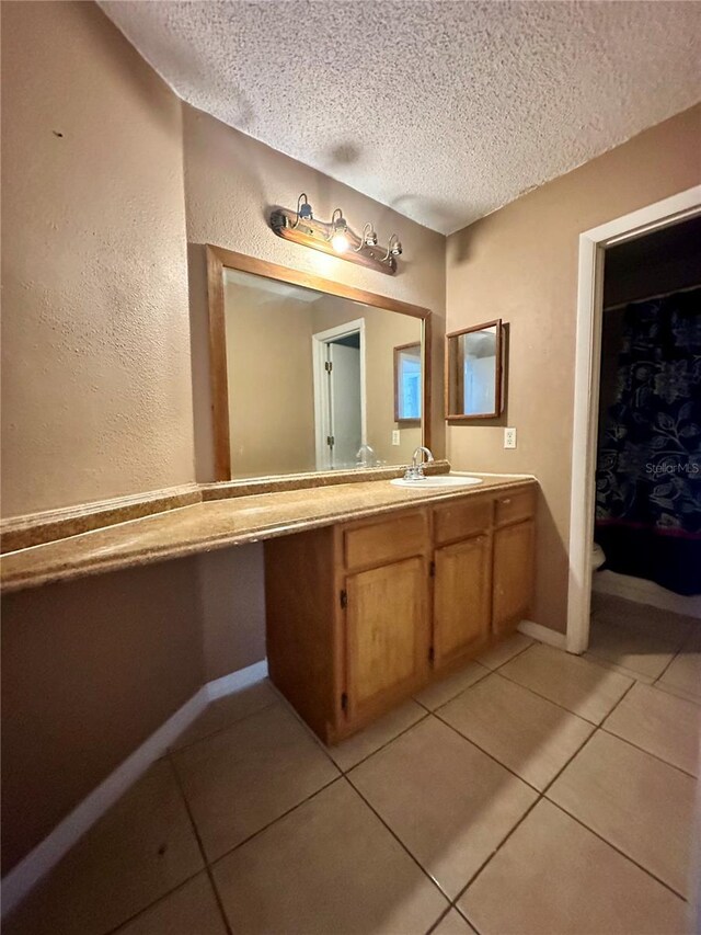 4350 Aqua Vista Dr Unit G, Orlando, FL 32839 - bathroom featuring tile patterned floors, a textured ceiling, vanity, and baseboards