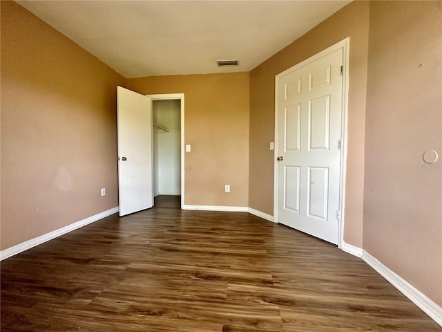 4350 Aqua Vista Dr Unit G, Orlando, FL 32839 - unfurnished bedroom featuring visible vents, a closet, dark wood-style floors, and baseboards