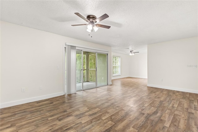 4038 Versailles Dr Unit 4038C, Orlando, FL 32808 - spare room featuring baseboards, a ceiling fan, wood finished floors, and a textured ceiling