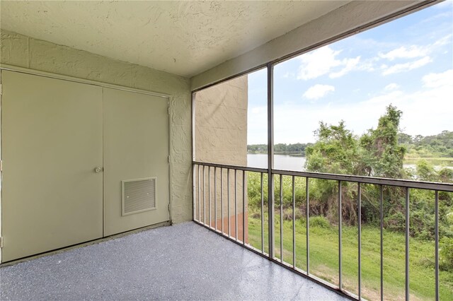 4038 Versailles Dr Unit 4038C, Orlando, FL 32808 - unfurnished sunroom featuring visible vents and a water view