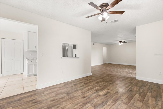 4038 Versailles Dr Unit 4038C, Orlando, FL 32808 - empty room featuring baseboards, a ceiling fan, wood finished floors, and visible vents