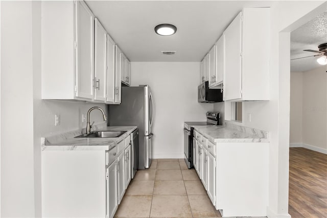 4038 Versailles Dr Unit 4038C, Orlando, FL 32808 - kitchen featuring a sink, light countertops, baseboards, appliances with stainless steel finishes, and visible vents
