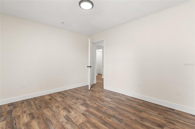 4038 Versailles Dr Unit 4038C, Orlando, FL 32808 - empty room featuring baseboards and dark wood-type flooring