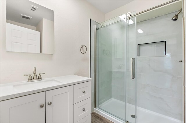 4038 Versailles Dr Unit 4038C, Orlando, FL 32808 - bathroom with a shower stall, vanity, and visible vents