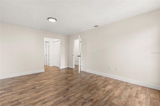 4038 Versailles Dr Unit 4038C, Orlando, FL 32808 - unfurnished room featuring baseboards, wood finished floors, and visible vents