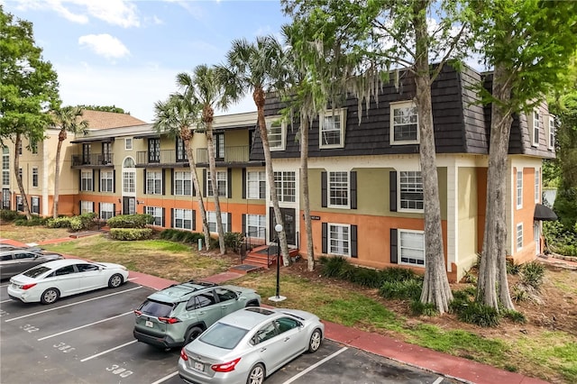4038 Versailles Dr Unit 4038C, Orlando, FL 32808 - view of building exterior featuring uncovered parking