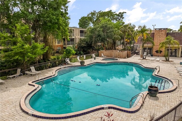 4038 Versailles Dr Unit 4038C, Orlando, FL 32808 - community pool featuring a patio area, french doors, a hot tub, and fence