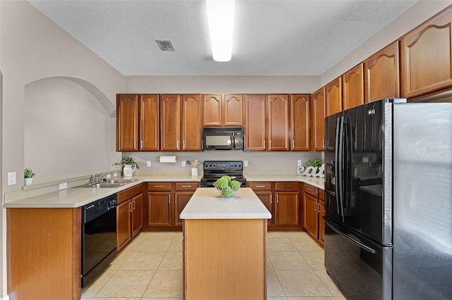 16064 Old Ash Loop, Orlando, FL 32828 - kitchen featuring a sink, light countertops, brown cabinetry, a kitchen island, and black appliances