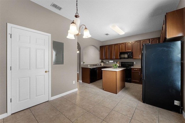 16064 Old Ash Loop, Orlando, FL 32828 - kitchen with a kitchen island, visible vents, light countertops, light tile patterned floors, and black appliances