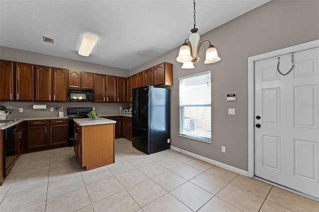 16064 Old Ash Loop, Orlando, FL 32828 - kitchen featuring hanging light fixtures, light countertops, a chandelier, a center island, and black appliances