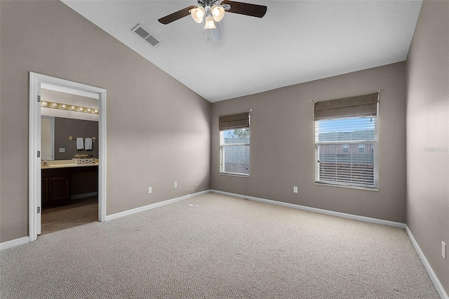 16064 Old Ash Loop, Orlando, FL 32828 - unfurnished bedroom with baseboards, light carpet, vaulted ceiling, and visible vents