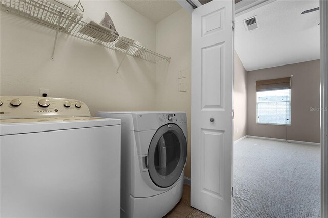 16064 Old Ash Loop, Orlando, FL 32828 - clothes washing area with laundry area, visible vents, washing machine and dryer, baseboards, and carpet flooring