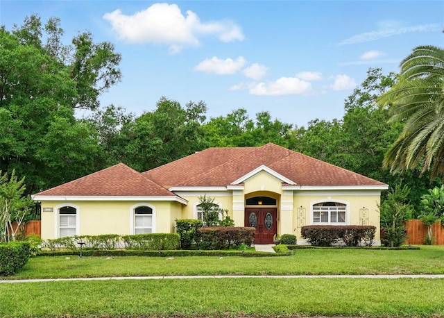 1714 Sweetwater W Cir, Apopka, FL 32712 - mediterranean / spanish-style house with stucco siding, a front lawn, and fence