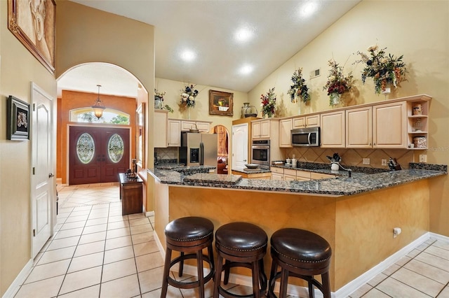 1714 Sweetwater W Cir, Apopka, FL 32712 - kitchen featuring stainless steel appliances, arched walkways, decorative backsplash, and light tile patterned floors