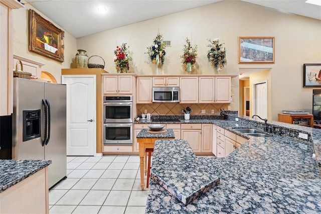 1714 Sweetwater W Cir, Apopka, FL 32712 - kitchen with stainless steel appliances, a sink, tasteful backsplash, lofted ceiling, and light tile patterned floors