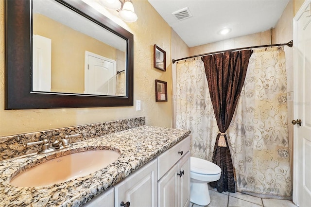 1714 Sweetwater W Cir, Apopka, FL 32712 - full bathroom featuring tile patterned floors, toilet, visible vents, a textured wall, and vanity